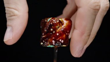 Kızarmış karamel hamurlu renkli sarmal şekerlemeler soyuluyor, Yavaş Çekim Yakın çekim.