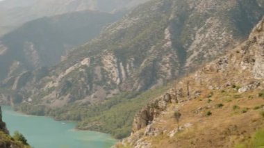 Turkuaz Gölü ve Engebeli Dağ yamaçlarından çarpıcı bir manzara, Yüksek Dağ Yolu 'ndan yakalanmış, Ağır Çekimde Görkemli Manzarayı vurguluyor.
