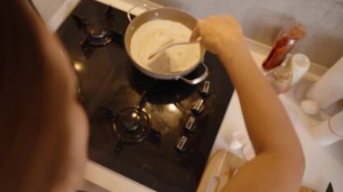 Tortilla 'yı pişirmek için ahşap bir Spatula ve tavada yumurta kullanmak..