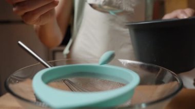 Bir Kişi Bir Kaşık Unu Bir Cam Kase Üzerine Sieve Kaşık Eklerken, İçindekileri Pişirmeye Hazırlanıyor. Yavaş çekim.