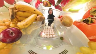 Buzdolabının içinde, bir adam taze ve canlı bir şekilde renkli ürünlerin arasında yakalanan sebzelerden uzaklaşırken verdiği kararı düşünen bir et paketi tutuyor..