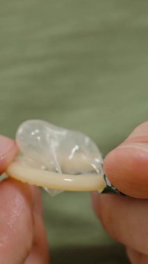 Dikey video. Kullanıma hazırlarken, Güvenli Uygulama ve Detaylara Dikkat Ederken, Eller Kondomu Hafifçe Açar