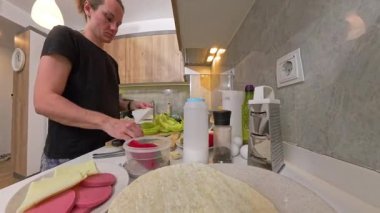 Mutfak tezgahında İçindekileri Hazırlayan Bir Kadın Geniş Açı Görünüm, Bir Tabak Peynir, Sosis ve Önde Tortilla Paketleri, Yemek İçin Hazır