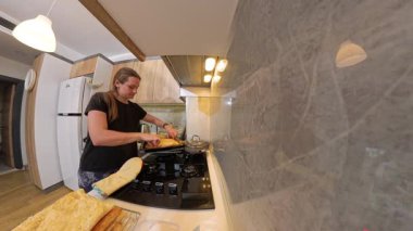 Fırın Eldiveni Giyen Kadın Ahşap Dolaplı İyi aydınlatılmış bir mutfakta Pasta Tabağı Tutan Kadın