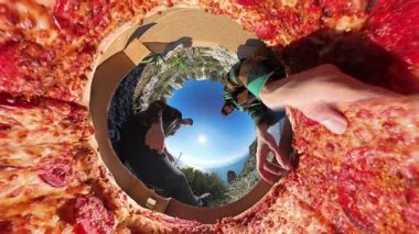 Bir Açık Kutudan Pizza Dilimlerine Erişen İki Kişi 360 derecelik Ufacık Gezegen Efekti ile yakalanmış, Manzaralı Eşsiz bir Perspektif ve Parlak Mavi Gökyüzü