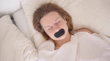 Sabah Işığında Beyaz Battaniyenin Altında Bantlanmış Ağızla Parlak Yatak Odasında Uykudan Kurtulma Konsepti İçin Huzur İçinde Yatan Kadın