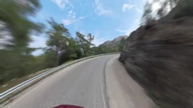 Zaman turları Kırmızı Araba Virajlı Dağ yolunda hareket ediyor Hareket Bulanıklığı Hızı ve Manzarayı Vurguluyor