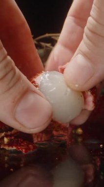 Tohum ve Pulp ile el ele tutuşan Lychee 'yi Parlak Yüzeye yerleştirirken Tam Meyveler ve Yapraklar Arkaplanda Stüdyo Işığıyla Yakından Yakından Çekildi