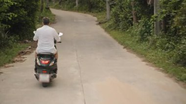 Yeşil Scooter Sola Dar Tropikal Yol 'a dönen Palmiye Ağaçları ve Bulanık Hareket, Arka Görüş Eylem Çekimi, Ada Keşfi