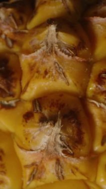 Dikey video. Tüm Küçük Ananas Dönüyor ve Düşüyor Makro Zoom Sarı desenli deri ve Siyah Meyve Kavramına Karşı Yeşil Taç Gösteriyor