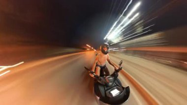 Dynamic Wide Angle View of Person Riding Scooter with Vibrant Light Trails and Timelapse Effect with a Sensation of Speed and Urban Energy. Gece Sokak Macerası