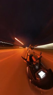 Dynamic Wide Angle View of Person Riding Scooter with Vibrant Light Trails and Timelapse Effect with a Sensation of Speed and Urban Energy. Gece Sokak Macerası
