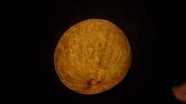 Spinning Santol Being Spinning Santol Being Spinted split by Hands Revealing Juicy White Pulp Inside, Capved Mid-Motion with Overhead View and Blur Effect, Exotic Fruit Concept