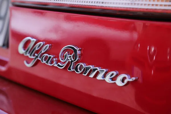 stock image Italy, year 2023, metallic logo of the Alfa Romeo Spider Duetto vintage car, public automotive exhibition of classic cars