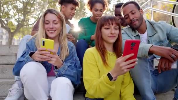 Unga Glada Vänner Som Har Roligt Tillsammans Med Mobiltelefon Sittande — Stockvideo