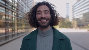 Kendine güvenen genç hippi yaratıcı işadamı ile takım çalışması kavramı kameraya doğru yürüyor. Ardından da şehrin finans bölgesindeki çok ırklı iş adamları geliyor..