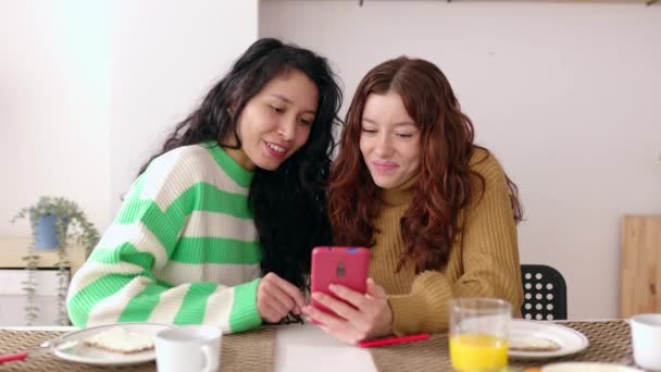 Young Female Friends Using Mobile Phone Together While Having Breakfast — Stock video