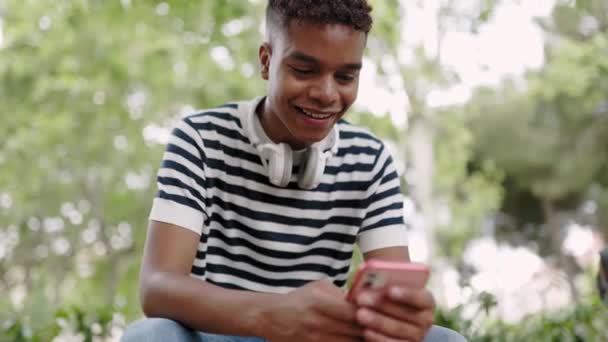Young Latin American Teenage Boy Using Mobile Phone Millennial Student — Vídeo de stock
