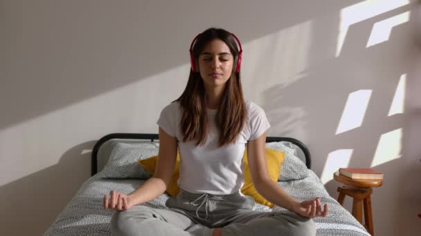 Young Adult Pretty Woman Breathing Headphones Meditating Bed Listening Music — Stockvideo