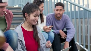 Üniversite kampüsünde dizüstü bilgisayarda ödev ya da grup projesi yapan çeşitli genç üniversite öğrencileri. Milenyum sınıf arkadaşları açık havada bir sınav hazırlıyor. İşbirliği, takım çalışması ve eğitim.