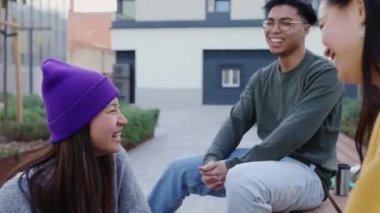 Genç bir grup çok ırklı arkadaş şehir sokaklarında konuşuyor ve birlikte eğleniyorlar. Asyalı gençler birlikte kutlama yapıyorlar. Günlük anların tadını çıkarıyorlar. Topluluk, dostluk ve mutluluk kavramı