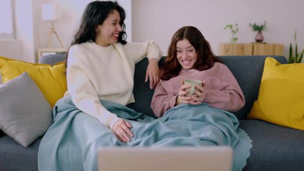 Two Young Female Roommates Covered Blue Blanket Relaxing Sofa Watching — Stock Video