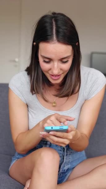 Szczęśliwa Młoda Kobieta Świętująca Sukces Patrząc Ekran Telefonu Komórkowego Siedząc — Wideo stockowe