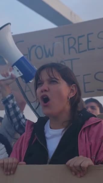 ビデオ 工場の前で気候変動に反対する多様な抗議者が集まりました プラカードを保持し 拳を上げる活動家による地球温暖化コンセプト — ストック動画