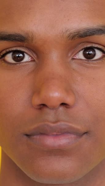 노란색 배경에 카메라에 아프리카 얼굴의 클로즈업 초상화 긍정적인 청소년 — 비디오