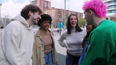 Genç bir grup insan dışarıda eğleniyor. Dört farklı milenyum arkadaşı açık havada eğleniyor. Gençlik toplumu ve arkadaşlık kavramı.