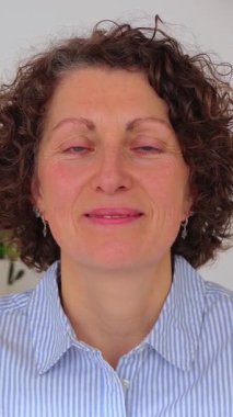 Dikey video. Ofiste çalışan, laptopta iş arkadaşını dinleyen 50 'lerin iş kadınının POV ekran görüntüsü. Olgun girişimci kadın partneriyle online görüşme yoluyla konuşuyor.