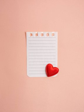 torn sheet from a notebook with hearts on a light background. Valentine concept. Greeting card. Flat lay, top view. Copy space.
