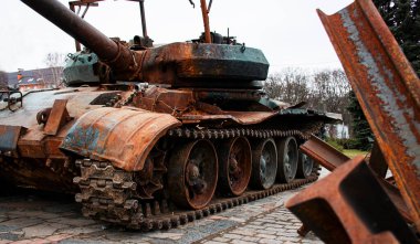 A broken Russian tank and anti-tank hedgehogs. Display of the destroyed military equipment of the Russian occupiers in the city of Kremenchuk, Ukraine. Remains of military equipment.