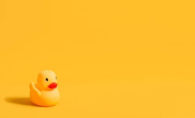 Rubber duck for swimming on a yellow background. Children's toy. Banner. Copy space.