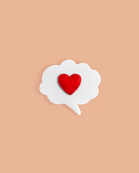 Chat icon with a heart on a beige background. Virtual relationships and love online. Dating in a social network. Modern love. Copy space.