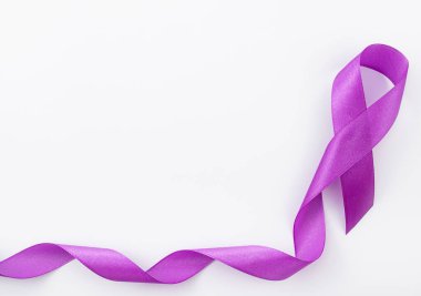 World Cancer Day. Purple ribbon on gray background with copy space for text. Cancer ribbon.