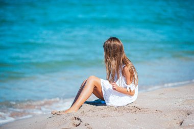 Adorable girl at tropical beach on vacation