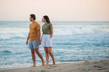 Romantic couple in love walking on the beach on romantic honeymoon travel