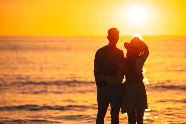 Romantic couple in love on the beach at sunset on romantic honeymoon travel