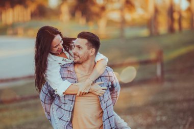 Happy couple in the park on summer day outdoors. High quality photo