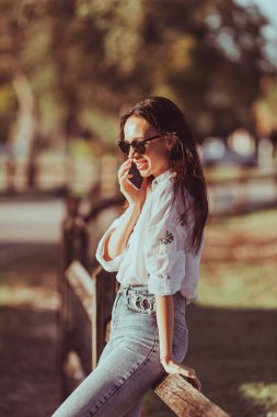 Young woman using mobile phone. High quality photo