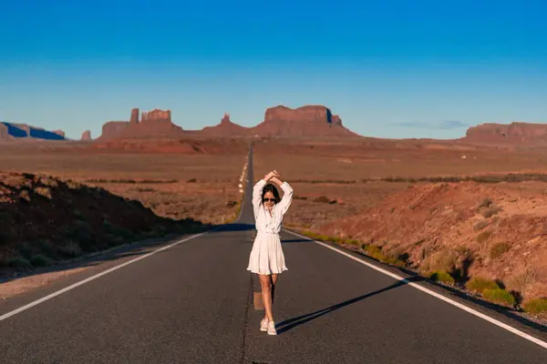 stock image Scenic highway in Monument Valley Tribal Park in Utah. Young woman on famous road in Monument Valley