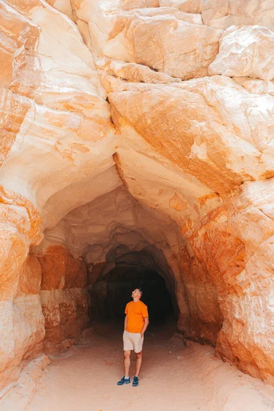 stock image Young man hike on popular trail Belly of the Dragon Tunnel Cave in Kanab