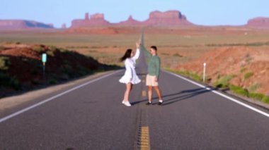 Utah 'taki Monument Valley Kabile Parkı' nda manzara otoyolu. Anıt Vadisi 'ndeki ünlü yolda genç bir aile.