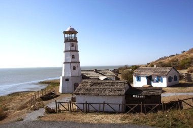 Autumn October photo lighthouse on the seashore. clipart