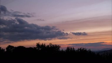 Time lapse of beautiful sky scenery with clouds at sunset. Aerial view of the clouds above the sky with the golden rays of the sun.
