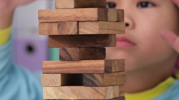 Cute Little Girl Playing Wooden Game Jenga Table Room Home — Vídeo de Stock