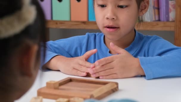 Little Siblings Playing Wooden Board Game Tic Tac Toe Table — Stockvideo