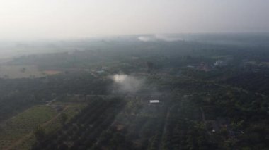 View of the horizon with smoke in countryside landscape. Rural air pollution.