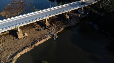 Aerial view of renovation and repair work on the river bridge road.